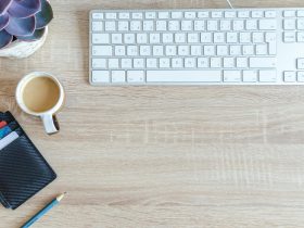 white apple keyboard near white cup